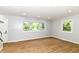 Bright living room with updated floors, neutral wall color, and large windows offering natural light and views at 5721 Daphne Dr, Indianapolis, IN 46278