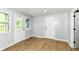Bright room with wood flooring, white trim, and doors, illuminated by natural light from the window at 5721 Daphne Dr, Indianapolis, IN 46278