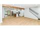 Open-concept design with new floors seamlessly connecting the living room, staircase and kitchen with island at 5721 Daphne Dr, Indianapolis, IN 46278