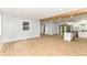 Spacious living area flows into the kitchen, highlighting the new flooring, neutral paint, and natural light at 5721 Daphne Dr, Indianapolis, IN 46278
