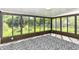 Enclosed sunroom with multiple windows providing natural light and view of the backyard at 5721 Daphne Dr, Indianapolis, IN 46278