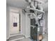 Basement area with furnace, water heater, and doorway to a bathroom at 5811 King Ave, Indianapolis, IN 46228