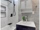 Modern bathroom featuring a sleek vanity, tiled walls, a stylish fixtures and bathtub at 5811 King Ave, Indianapolis, IN 46228