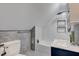 Bathroom features gray and white tile with modern fixtures and a bathtub at 5811 King Ave, Indianapolis, IN 46228