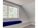 Sunlit bedroom nook with soft gray walls, and large window overlooking the trees at 5811 King Ave, Indianapolis, IN 46228