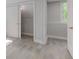 Open bedroom featuring light wood floors, and closet with bright, natural light at 5811 King Ave, Indianapolis, IN 46228