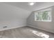 Bright bedroom featuring wood floors, a window, and neutral paint, creating a calm atmosphere at 5811 King Ave, Indianapolis, IN 46228