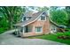 Charming stone two-story home with a gravel driveway and covered porch at 5811 King Ave, Indianapolis, IN 46228