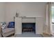 Cozy fireplace with a painted brick surround at 5811 King Ave, Indianapolis, IN 46228