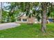 Charming home featuring brick exterior, enclosed porch, and a neatly maintained front yard at 5811 King Ave, Indianapolis, IN 46228