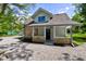 Charming house with brick and siding, featuring a covered porch and gravel driveway at 5811 King Ave, Indianapolis, IN 46228