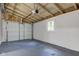 Spacious garage interior with concrete floors, overhead door and natural light at 5811 King Ave, Indianapolis, IN 46228