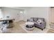Bright living room featuring a gray sofa and a view to the front entry door at 5811 King Ave, Indianapolis, IN 46228