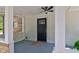 Covered porch with black front door, columns, and a ceiling fan at 5811 King Ave, Indianapolis, IN 46228