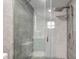 Walk-in shower features gray tiles and a rainfall shower head with a handheld wand at 5811 King Ave, Indianapolis, IN 46228