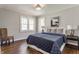 Bedroom featuring dark wood floors, neutral paint, and a large bed with a patterned blanket and pillows at 5912 Evanston Ave, Indianapolis, IN 46220