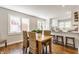 Dining room features seating for six, hardwood floors, lots of windows, and opens to the kitchen at 5912 Evanston Ave, Indianapolis, IN 46220