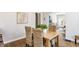 Bright dining room features wood floors, seating for four, and natural light from windows at 5912 Evanston Ave, Indianapolis, IN 46220