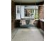Relaxing front porch swing with cushions and rug, offering a cozy outdoor space and view of the yard at 5912 Evanston Ave, Indianapolis, IN 46220