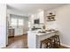 Bright kitchen features stainless steel appliances, white cabinetry, and barstool seating for three at 5912 Evanston Ave, Indianapolis, IN 46220