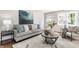 Bright living room featuring stylish decor, neutral furniture, decorative pillows, and an open, airy ambiance at 5912 Evanston Ave, Indianapolis, IN 46220