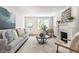 Stylish living room with a fireplace, neutral-toned furniture, an area rug, and a bright, airy ambiance at 5912 Evanston Ave, Indianapolis, IN 46220