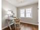 Office featuring dark wood floors, neutral paint, and a desk with a lamp and picture at 5912 Evanston Ave, Indianapolis, IN 46220