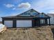 Charming new construction home with a brick facade, attached garage, and unfinished landscaping at 6025 Madera Dr, Whitestown, IN 46075