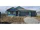 A new home under construction, featuring a two-car garage and covered porch in a residential area at 6046 Granby Dr, Whitestown, IN 46075