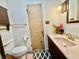 Bathroom with a toilet, vanity, and unique rug, creating a practical and aesthetically pleasing space at 6335 Linden Dr, Indianapolis, IN 46227