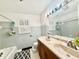 Bathroom featuring a double vanity, large mirror, and a shower/tub combination, providing space and comfort at 6335 Linden Dr, Indianapolis, IN 46227