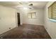 Bedroom with neutral tones, a ceiling fan, and large windows, creating a comfortable and inviting space at 6335 Linden Dr, Indianapolis, IN 46227