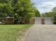 Charming brick ranch home with a two car garage and mature trees at 6335 Linden Dr, Indianapolis, IN 46227