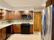 Kitchen showcasing wood cabinets, sleek appliances, and lots of countertop space at 6335 Linden Dr, Indianapolis, IN 46227
