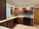 Updated kitchen with stainless steel microwave, ample counter space and wood cabinets at 6335 Linden Dr, Indianapolis, IN 46227