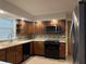 Well lit kitchen with wooden cabinets, white countertops and modern appliances at 6335 Linden Dr, Indianapolis, IN 46227