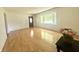 Bright living room featuring hardwood floors, large window and fresh paint at 6335 Linden Dr, Indianapolis, IN 46227