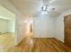 Open living room showcasing hardwood floors, ceiling fan and access to other rooms at 6335 Linden Dr, Indianapolis, IN 46227