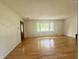 Spacious living room with hardwood floors, large window, and neutral paint at 6335 Linden Dr, Indianapolis, IN 46227