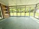 Enclosed sunroom with views of the green backyard through sliding glass doors at 6335 Linden Dr, Indianapolis, IN 46227