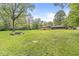 Expansive backyard features a fire pit and detached garage, surrounded by lush greenery at 6401 N Oakland Ave, Indianapolis, IN 46220