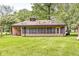 Expansive backyard featuring a screened-in porch, perfect for enjoying the outdoors, and well-maintained lawn at 6401 N Oakland Ave, Indianapolis, IN 46220