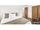Cozy bedroom features hardwood floors, closet, comfortable bed, and modern chair for a relaxing retreat at 6401 N Oakland Ave, Indianapolis, IN 46220