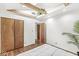 Bright bedroom with hardwood floors, exposed beams, closet, and a green plant for a serene ambiance at 6401 N Oakland Ave, Indianapolis, IN 46220