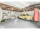 Spacious garage with a vintage car, workbench, shelving, and a boxing bag, perfect for hobbyists at 6401 N Oakland Ave, Indianapolis, IN 46220