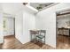 A hallway featuring hardwood floors and white walls at 6401 N Oakland Ave, Indianapolis, IN 46220