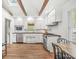 A kitchen featuring stainless steel appliances, hardwood floors, and white cabinets at 6401 N Oakland Ave, Indianapolis, IN 46220