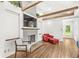 Inviting living room showcases a fireplace, exposed beams, hardwood floors, and views to a lush yard at 6401 N Oakland Ave, Indianapolis, IN 46220