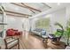 Spacious living room boasts hardwood floors, exposed beams, and comfortable seating, filled with natural light at 6401 N Oakland Ave, Indianapolis, IN 46220