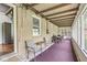 An enclosed back porch featuring a seating area and view of the back yard at 6401 N Oakland Ave, Indianapolis, IN 46220